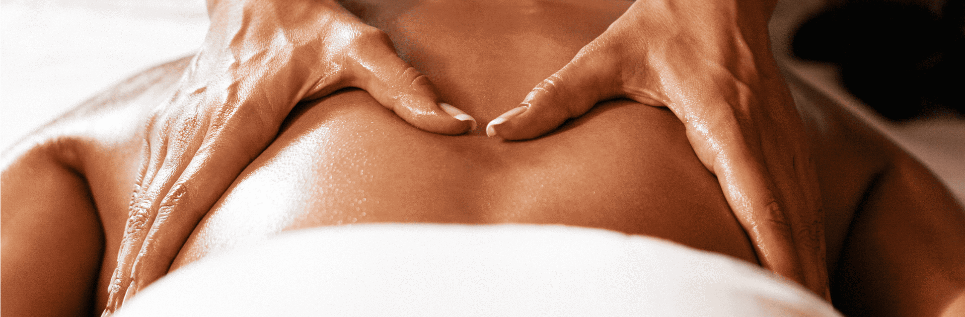 Thai massage therapist performing back massage in Glasgow spa setting.