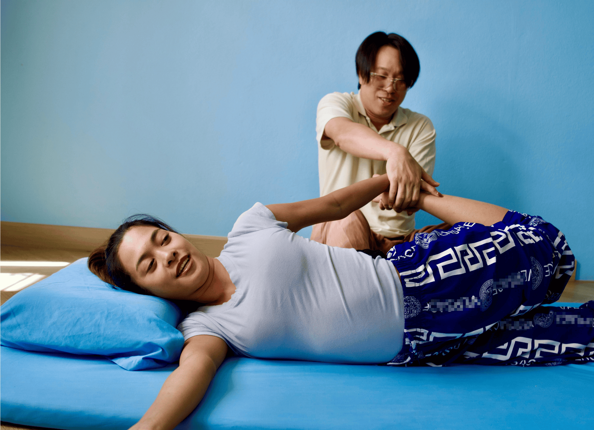 Woman receiving traditional Thai massage in Glasgow therapy centre.