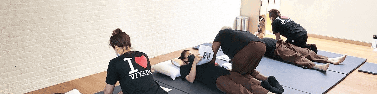 Thai massage session in Glasgow with therapists performing traditional techniques.