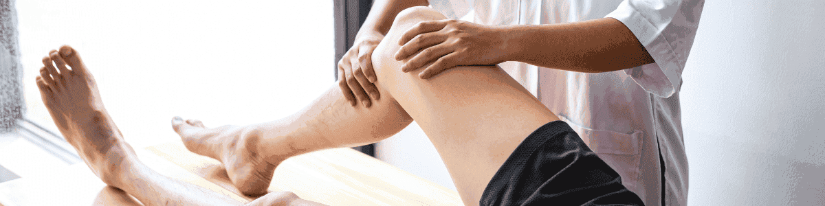 Thai massage therapist performing leg massage in Glasgow.