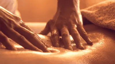 Skilled therapist performing Thai massage on a client in Glasgow clinic.