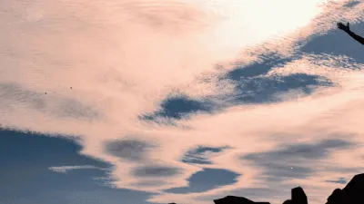 Person receiving Thai massage outdoors with sunset sky in Glasgow.