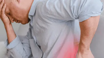 Thai massage therapist easing lower back pain in Glasgow.
